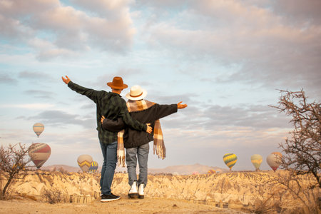 Couple in love travelers on vacation together in beautiful destination in Goreme, Turkey. Fabulous Kapadokya with flying air balloons at sunrise, Anatoliaの写真素材