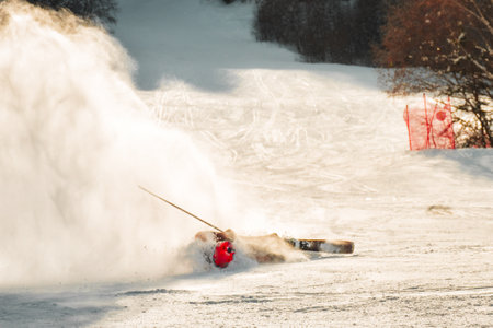 Close up dynamic picture of skier on the piste in Alps. Active winter holidays, skiing downhill in sunny day.の写真素材
