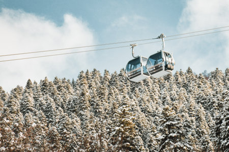 Zuruldi ski cabins over snowy forest with clear blue sky background. Mestia ski resort holiday destination in Georgia. Caucasus mountains.の写真素材