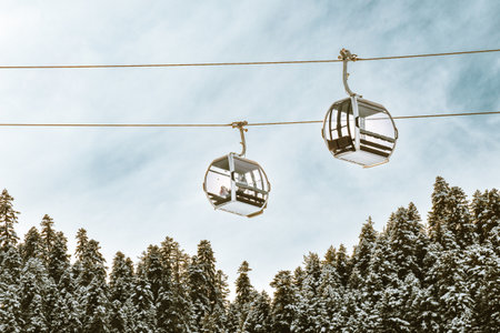 Zuruldi ski cabins over snowy forest with clear blue sky background. Mestia ski resort holiday destination in Georgia. Caucasus mountains.の写真素材