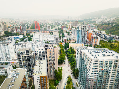 Aerial rising view construction site with crane carry block material and workers working. Real estate site in Saburtalo, Tbilisi, Georgiaの写真素材