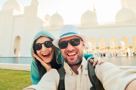 Portrait smiley young happy caucasian couple take smartphone selfie while having fun sightseeing...