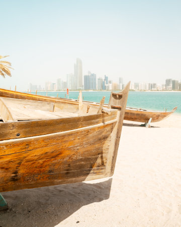 Abu Dhabi skyline with old traditional fishing boats in Heritage Village in Abu Dhabi in United Arab...