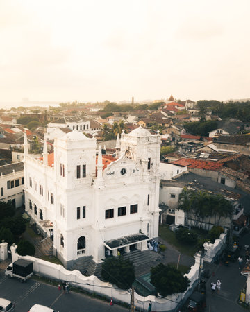 Aerial view white Meeran Mosque with colonial architecture in Galle Fort Sri Lanka surrounded by tiled rooftops and coastal old town buildings at golden hourの写真素材