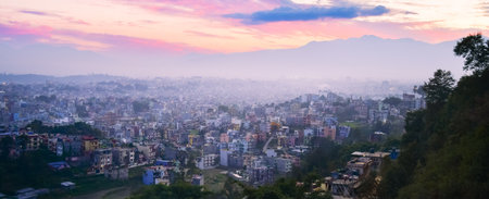 Beautiful panorama sunset over Nepal capital Kathmandu city with colorful buildings from viewpoint with Himalayas mountains backgroundの写真素材