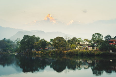 Annapurna mountain range reflection view on lake at sunset. Pokhara city and Phewa Lake, central Nepal. Annapurna mountain range snowy peaksの写真素材