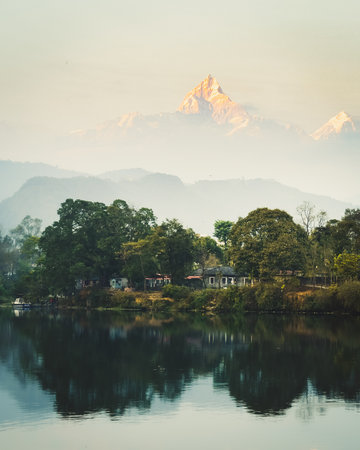 Annapurna mountain range reflection view on lake at sunset. Pokhara city and Phewa Lake, central Nepal. Annapurna mountain range snowy peaksの写真素材