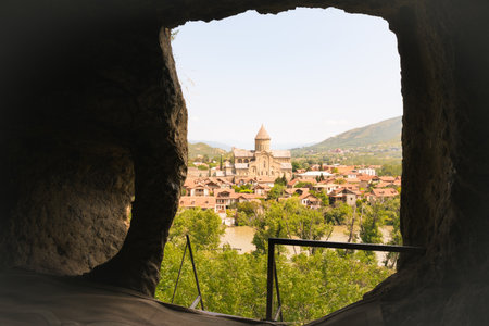Historic view of Svetitskhoveli Cathedral framed by a rock-hewn window, with Mtskhetaâ€™s...