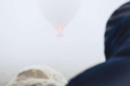 View from passenger in hot air balloon surrounded by thick mist highlighting adventure safety risk danger conceptの写真素材