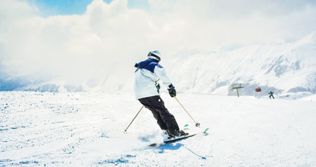 Close up banner experienced male skier on piste ski downhill carving fast motion in Alps. Active...