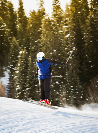 Close up young advanced male skier freeze motion ski jump downhill in Mestia hatsvali ski resort...