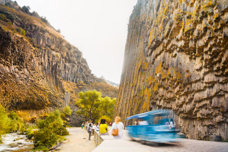 Motion people visit sightseeing popular travel destination in armenia - Basalt columns in Garni Gorge, know as Symphony of Stones. Geological formation of octagonal basalt columns. Motion blurの写真素材