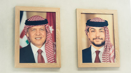 Aqaba, Jordan - 6th december, 2025: framed portraits of Jordan national leaders King Abdullah II and Hussein, Crown Prince of Jordan in in traditional attire on indoor wall. Modern monarchy symbolismのeditorial素材