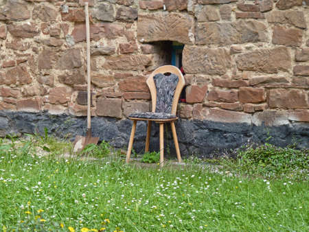 Forgotten chair and bucket front of the houseの写真素材