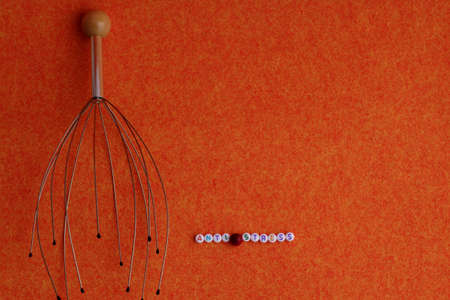 Head massager on an orange background orange and the inscription anti-stressの写真素材