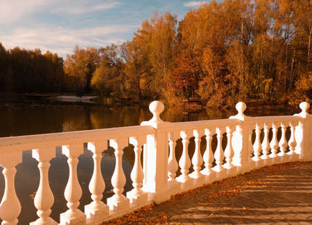 The shore of the First Lake with a view of the water surface, autumn trees and a white stone rotunda in the Star Cityの写真素材