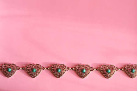 Concept for valentine's day. Ð¡hain of metal hearts on a light background with space for text or logo.の写真素材