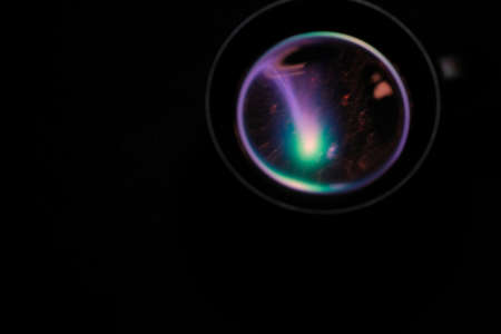 black mug on a black background with abstract neon reflectionの写真素材