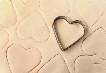 Dough for cookies. A mold for cutting cookies in the form of heart. Shortcake dough, St. Valentines Day. Top viewの写真素材