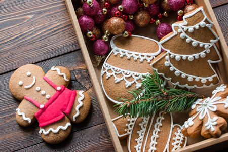 Christmas gingerbreads. Christmas decorations and handmade cookies on tray lying on the wooden background. Top view. Christmas and New Year.の写真素材