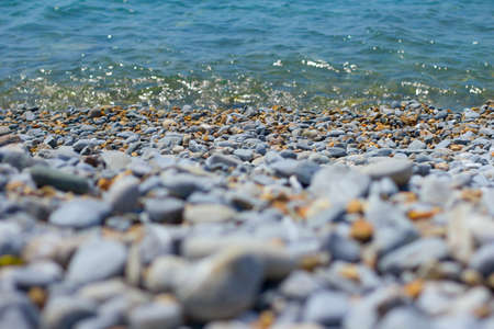 Pebble sea shore. Pebble beach and turquoise sea waterの写真素材