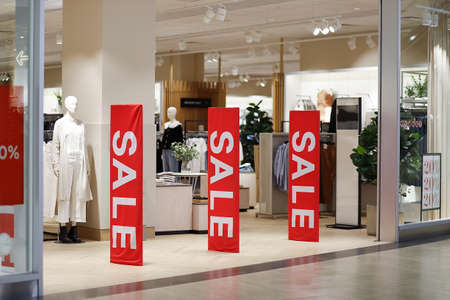 Sale in a clothing store. Entrance area to a clothing store with sale banners.の写真素材