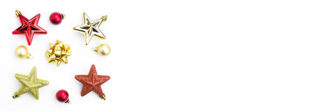 Christmas tree toys, red and gold stars, balls on a white background. Banner. Copy spaceの写真素材