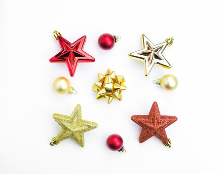Christmas tree toys, red and gold stars, balls on a white background.の写真素材