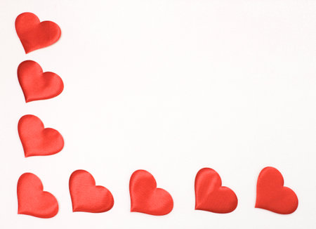 Corner frame of satin hearts on a white background. The concept of Valentines Day.の写真素材