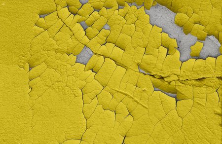 Cracked illuminating yellow paint on an old cement wall. The old background is painted illuminating yellow on the walls. Illuminating yellow colorの写真素材
