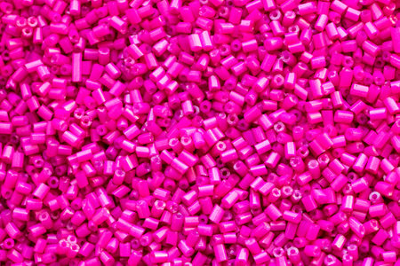 Background texture of hot pink beads closeup. Seamless beads texture. Hobbies, handmade jewelry, craft. Abstract backgroundの写真素材