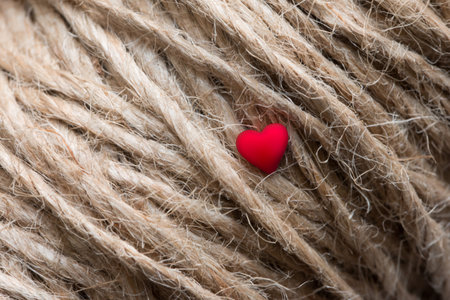 Red heart on the surface of the twine. Valentines Day background. Macroの写真素材