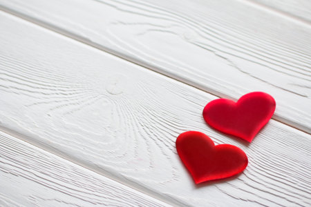 Two red hearts on a white wooden surface. Valentines Day backgroundの写真素材