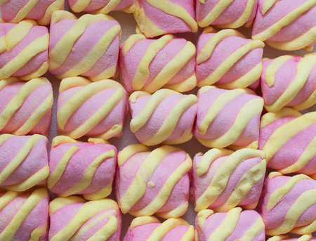 Top view on background texture of colorful marshmallow candies. Sweets of corn syrup, gelatin, sugar, and starch.の写真素材