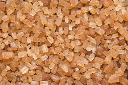 Close up of natural brown sugar texture. Brown sugar background. Raw sugar. Top view. Macroの写真素材