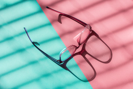 Purple glasses on two color background.の写真素材