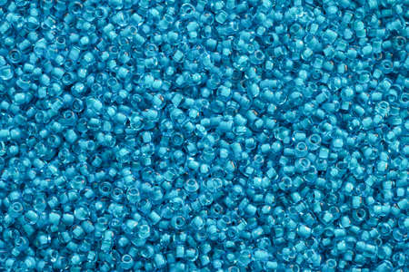 Background texture of turquoise color beads closeup. Seamless beads texture. Hobbies, handmade jewelry, craft. Abstract backgroundの写真素材