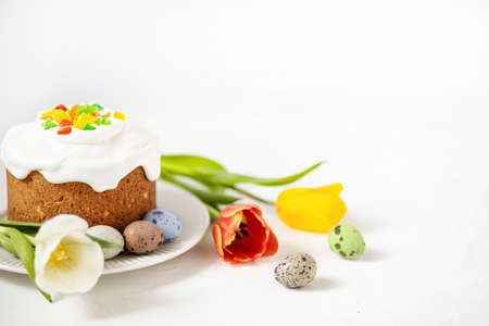 Easter composition with traditional Easter cake, painted quail eggs and tulips. Selective Focusの写真素材