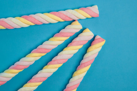 Spiral marshmallows on a blue background. Copy space.の写真素材