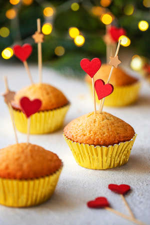 Saint Valentines Day dessert, cupcakes decorated with wooden hearts on white table. Love concept. Front view. Selective focus. Bokeh. The concept of Valentines Day.の写真素材