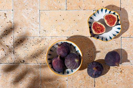 Sliced figs in a porcelain plate on the table. Top viewの写真素材