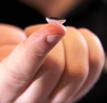 Holding a contact lense on a finger topの写真素材