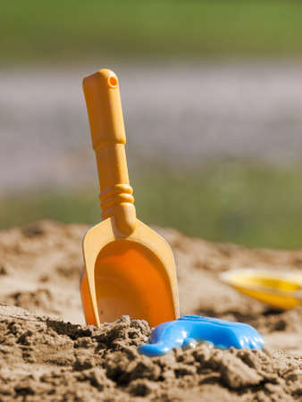 yellow scoop and blue form for playing to mud pie in sandの写真素材