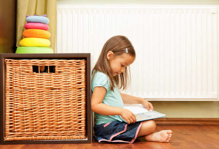 little girl reading a bookの写真素材