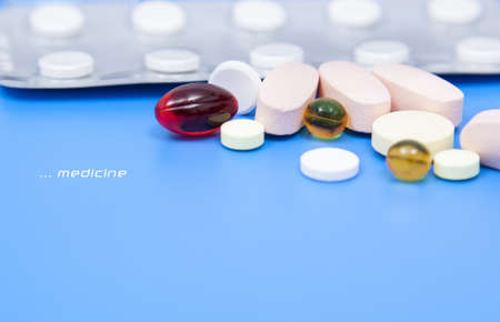 colored pills in a blue backgroundの写真素材