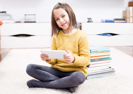 Smile girl playing on tablete
