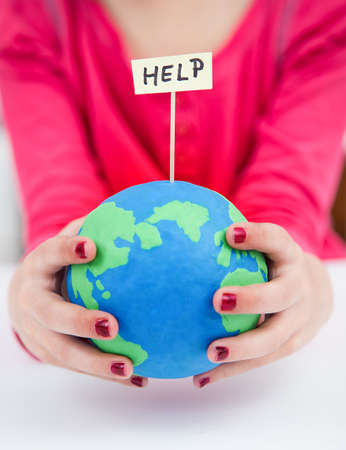 clay earth globe, saving the earth - helpの写真素材