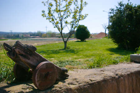 Old wooden wheelbarrow in the garden of houseの写真素材