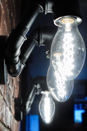 Lamp created from water pipes on the wall of the barの写真素材