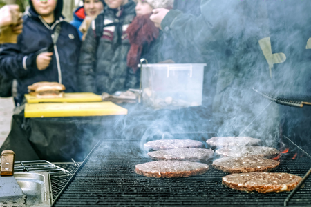 Cooking burgers picnoc on the street.の写真素材